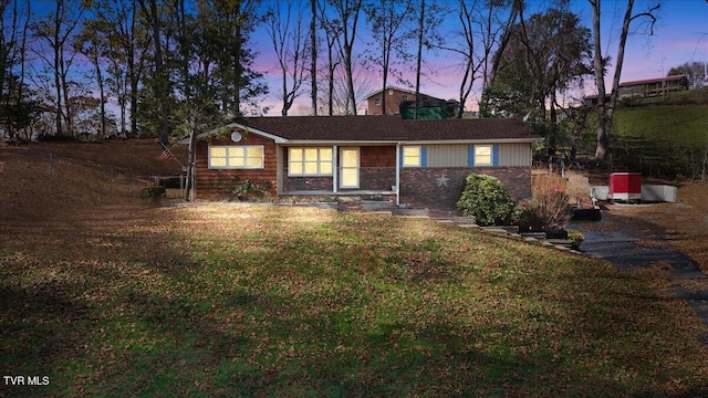 ranch-style house with a lawn