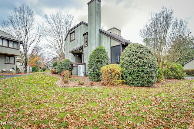 view of home's exterior with a yard