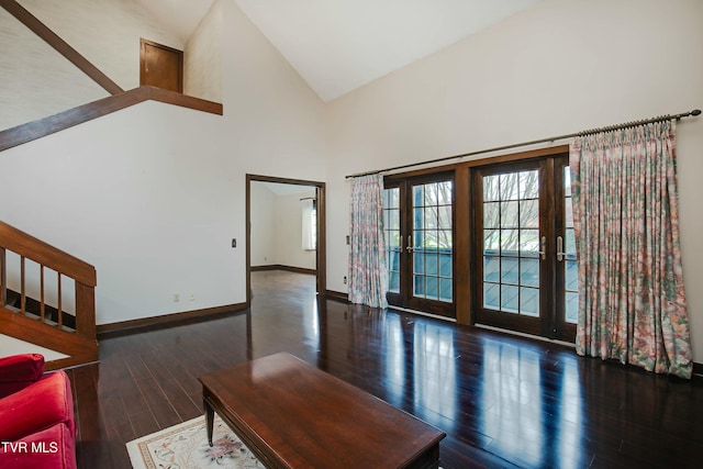 entrance foyer with dark hardwood / wood-style flooring, high vaulted ceiling, and french doors