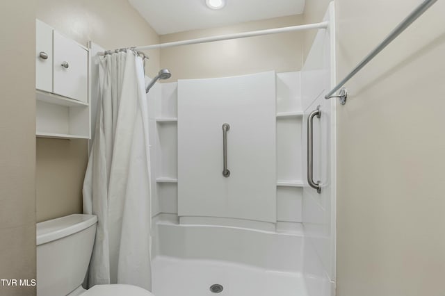 bathroom featuring toilet and walk in shower