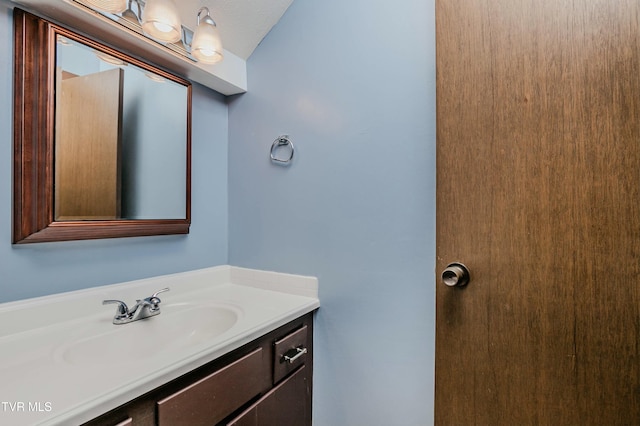 bathroom with vanity and a textured ceiling