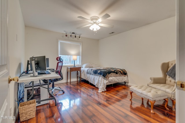 bedroom with ceiling fan, track lighting, and hardwood / wood-style flooring