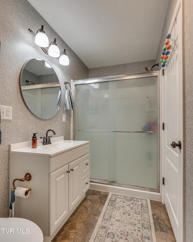 bathroom featuring vanity and a shower with shower door