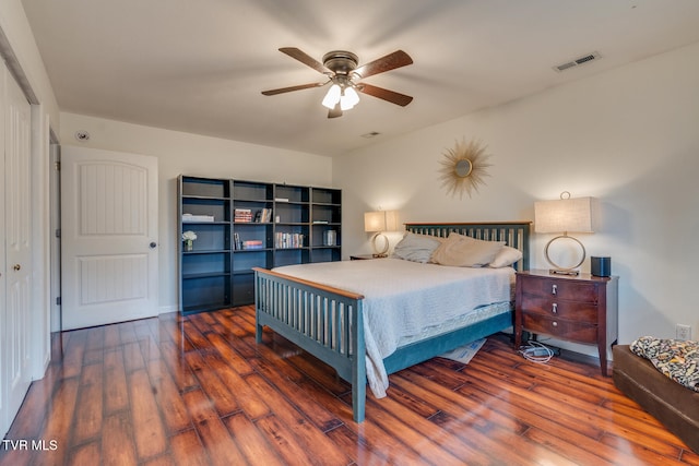 bedroom featuring ceiling fan, dark hardwood / wood-style flooring, and a closet