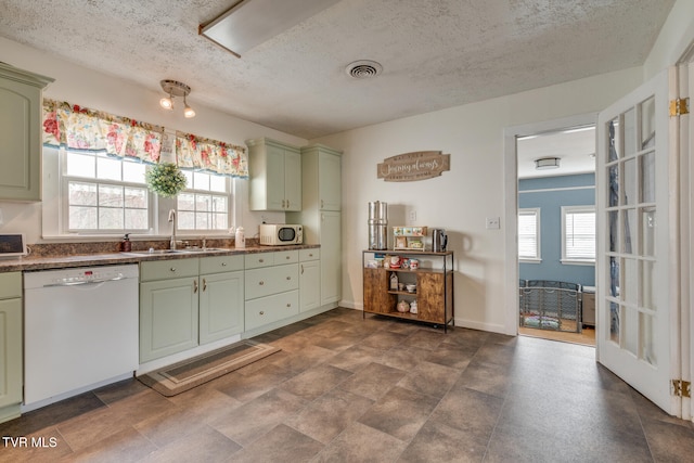 kitchen featuring white appliances, sink, a wealth of natural light, and green cabinetry