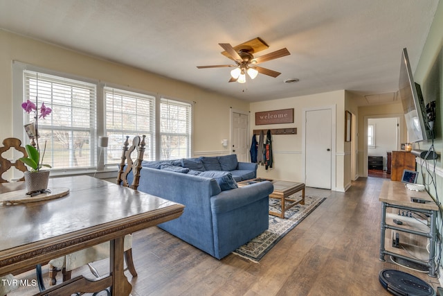 living room with ceiling fan, a healthy amount of sunlight, and dark hardwood / wood-style flooring