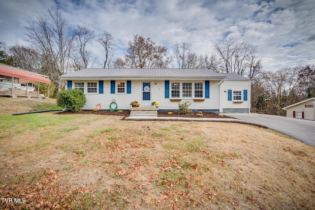 ranch-style house with a front yard and a carport