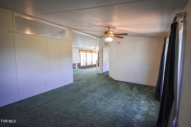 empty room featuring carpet, a textured ceiling, ceiling fan, and lofted ceiling