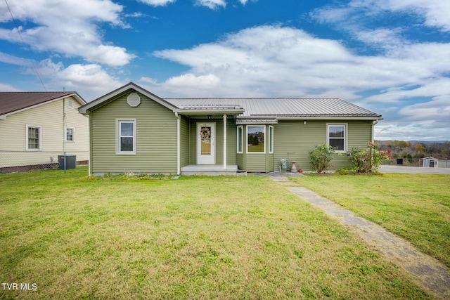 ranch-style home with a front yard and cooling unit