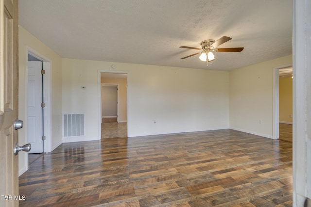 unfurnished room featuring a textured ceiling, ceiling fan, and dark hardwood / wood-style floors