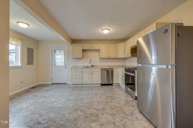 kitchen with electric panel, sink, a textured ceiling, and appliances with stainless steel finishes