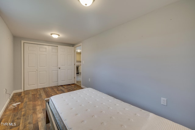 unfurnished bedroom with a closet and dark hardwood / wood-style floors