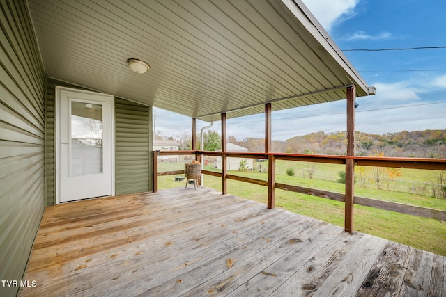 wooden terrace with a yard