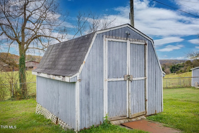 view of outbuilding with a yard