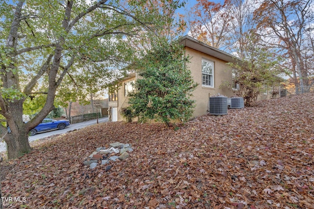 view of side of home with central AC