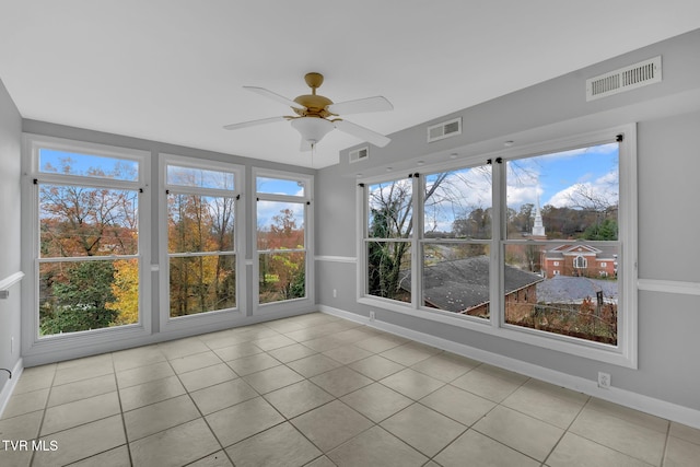 unfurnished sunroom with plenty of natural light and ceiling fan