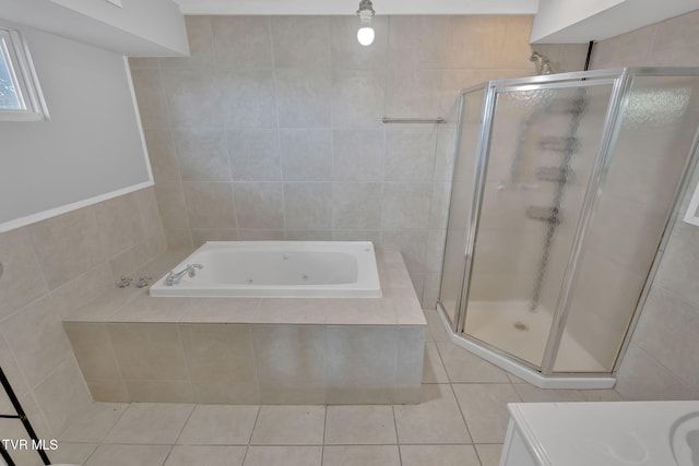 bathroom featuring tile patterned floors, shower with separate bathtub, and tile walls