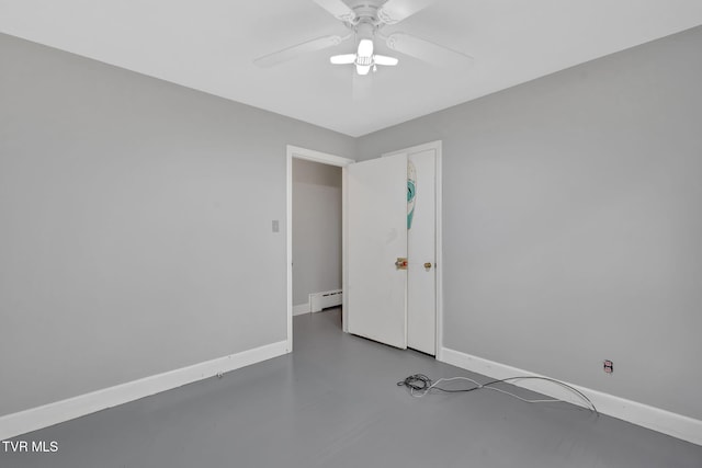 empty room featuring ceiling fan and a baseboard radiator