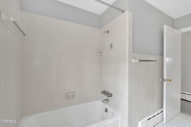 bathroom featuring a baseboard radiator, tile patterned floors, and tiled shower / bath