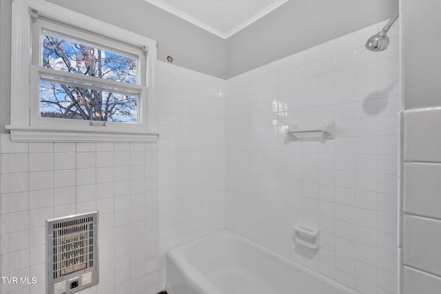 bathroom featuring heating unit, tiled shower / bath combo, and ornamental molding