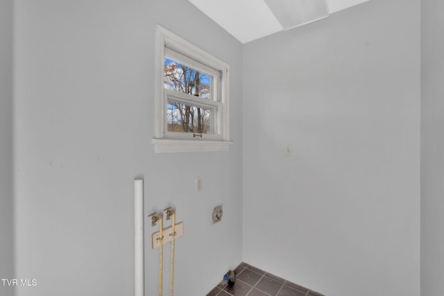 washroom with dark tile patterned flooring