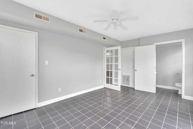 tiled spare room with ceiling fan