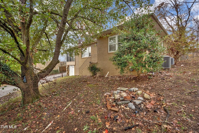 view of side of property with central AC unit