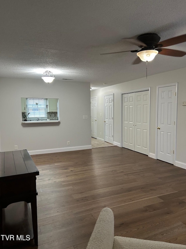 interior space with ceiling fan, hardwood / wood-style floors, and a textured ceiling