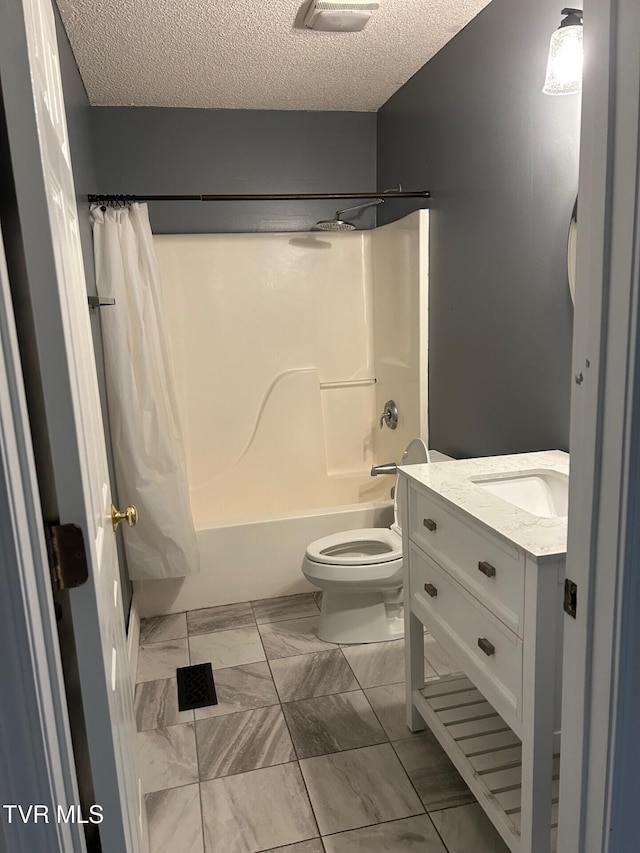 full bathroom with vanity, toilet, shower / bath combo with shower curtain, and a textured ceiling