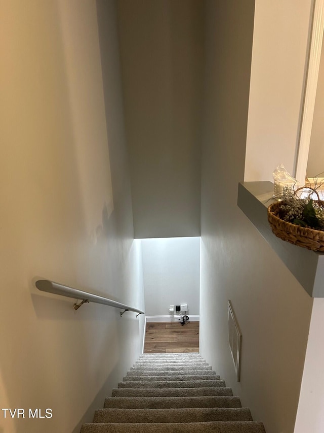 staircase featuring hardwood / wood-style floors