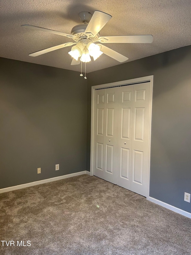 unfurnished bedroom featuring a textured ceiling, a closet, and ceiling fan