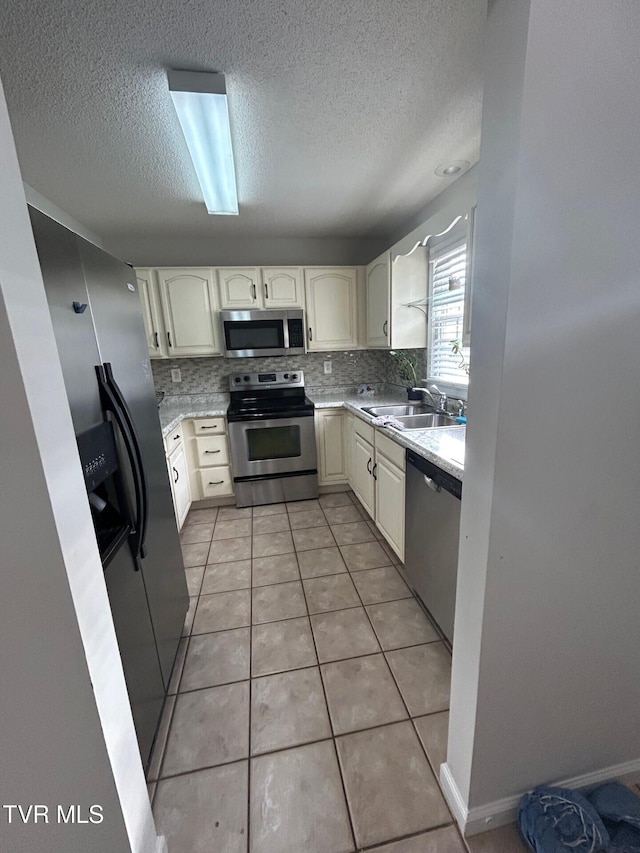 152 Gray Station Rd Unit 18, Gray, TN 37615 - kitchen featuring stainless steel appliances, a textured ceiling, tasteful backsplash, and light countertops