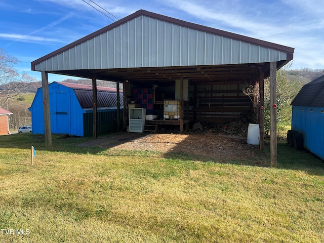 view of outdoor structure featuring a lawn and a carport