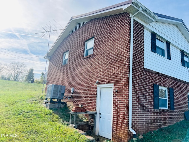 view of home's exterior with a yard and cooling unit