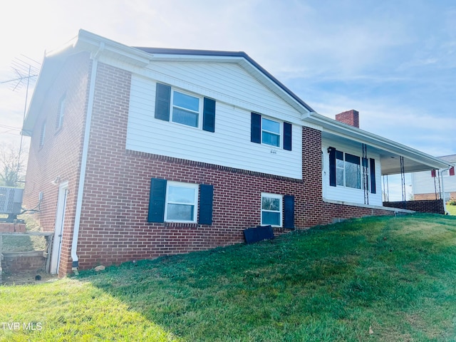 view of side of home with a yard