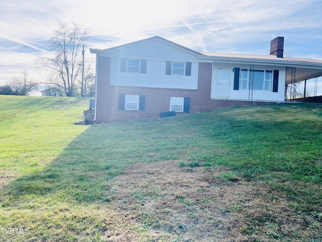 128 Graybeal Dr, Castlewood, VA 24224 - view of side of property featuring a chimney, a yard, brick siding, and a carport