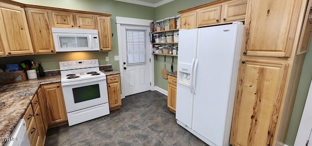 kitchen with dark stone countertops, white appliances, and crown molding