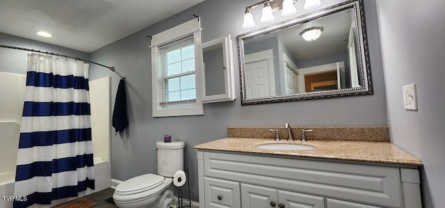 full bathroom featuring vanity, shower / tub combo, and toilet