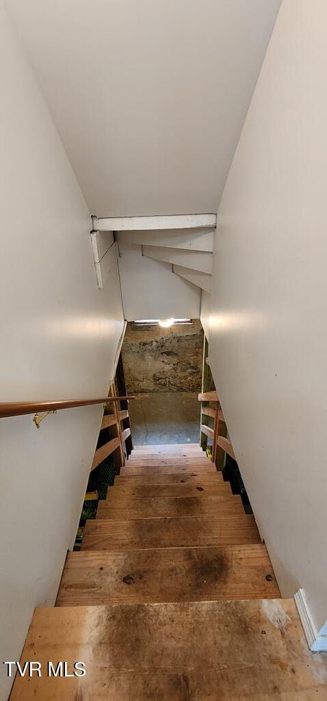 stairs featuring hardwood / wood-style flooring