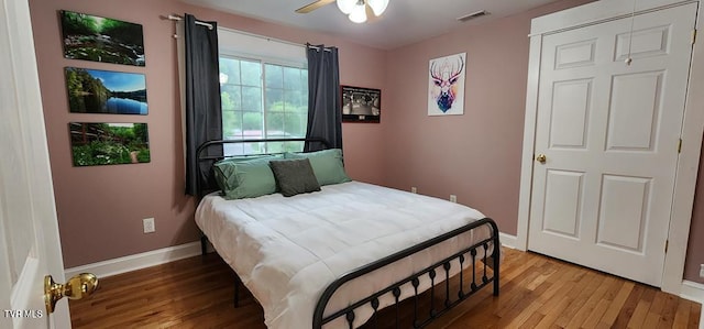 bedroom with hardwood / wood-style flooring and ceiling fan