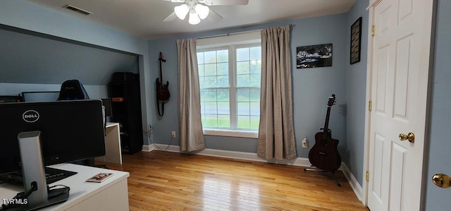 home office featuring ceiling fan and light hardwood / wood-style flooring