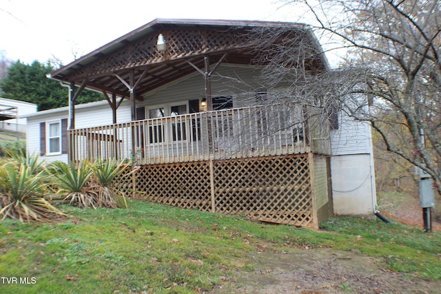 rear view of property featuring a deck