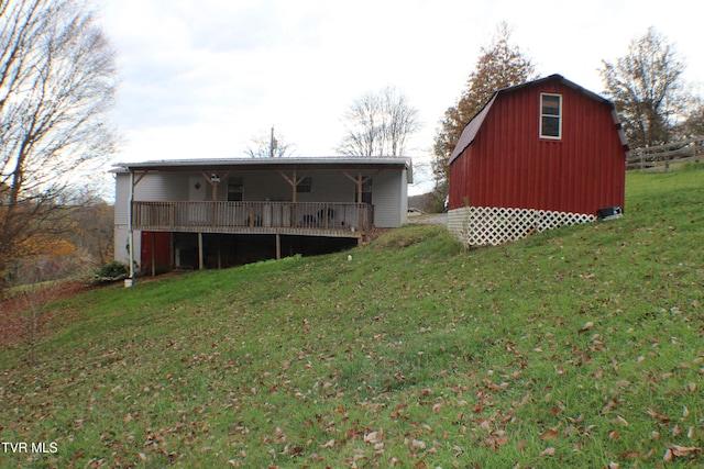 back of house with a lawn and an outdoor structure