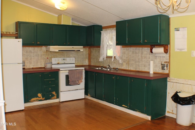 kitchen featuring lofted ceiling, white appliances, range hood, and green cabinetry