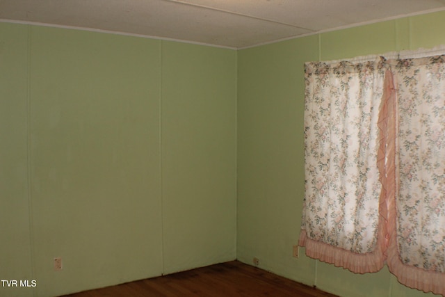 empty room with dark hardwood / wood-style flooring