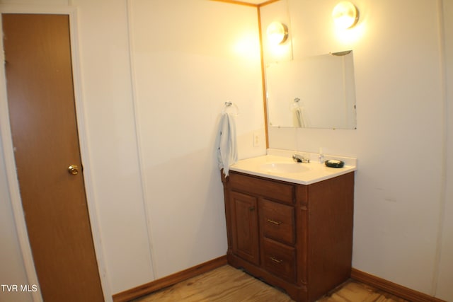 bathroom with hardwood / wood-style floors and vanity