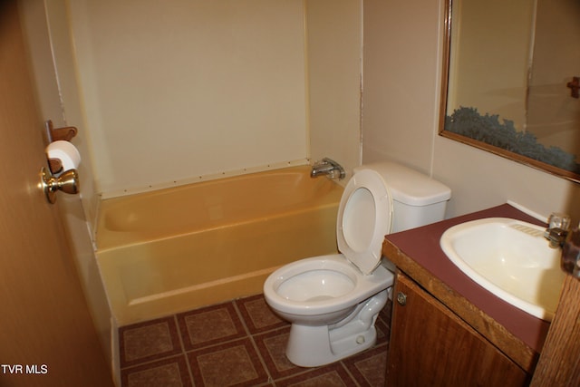 bathroom with a washtub, vanity, and toilet