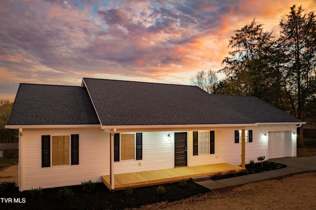 view of front of house featuring a garage and a wooden deck