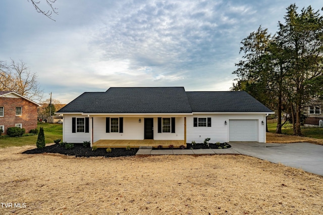 single story home featuring covered porch and a garage