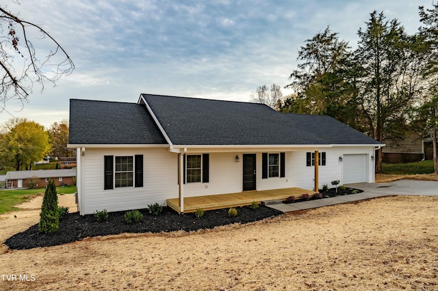 single story home featuring a porch and a garage